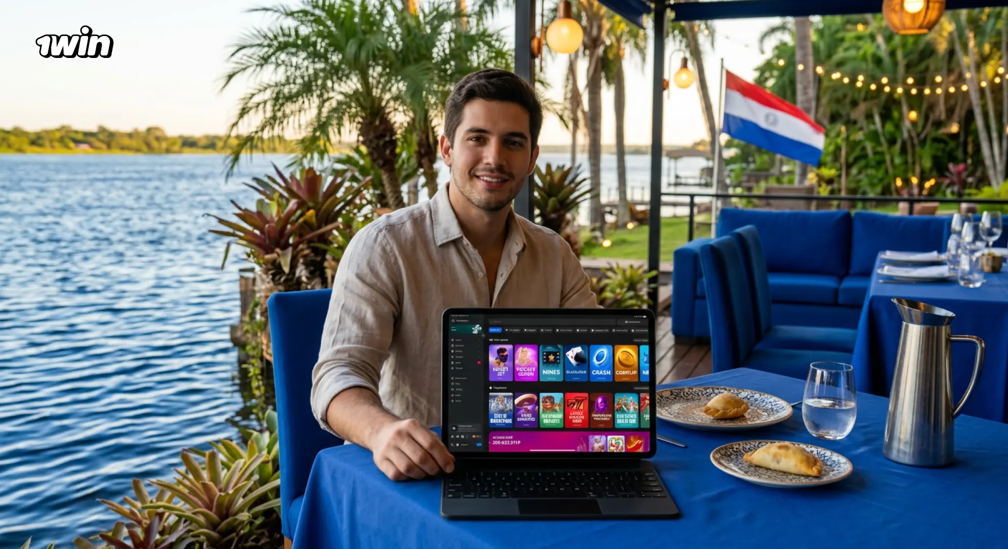 Jugador paraguayo con notebook mostrando el catálogo de 1win junto al río
